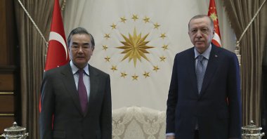 President Recep Tayyip Erdoğan (R) and Chinese Foreign Minister Wang Yi pose for photos before a meeting, in Ankara, Turkey, March 25, 2021. (AP Photo)