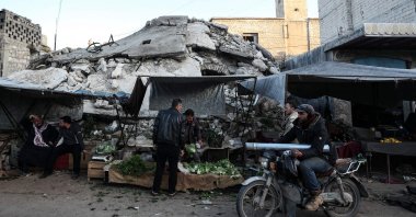 Syrians buy food products at a market ahead of iftar, the evening meal that ends the daily fast at sunset, on the second day of Ramadan, in the war-ravaged city of Ariha, located near the strategic M4 highway, in the southern countryside of the Idlib province, Syria, April 15, 2021. (AFP Photo)