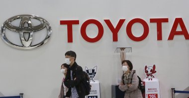 Visitors walk around a Toyota showroom in Tokyo, Japan, Nov. 2, 2020. (AP Photo)