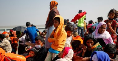 Rohingya refugees sit on wooden benches of a navy vessel on their way to the Bhasan Char island in Noakhali district, Bangladesh, Dec. 29, 2020. (Reuters/Mohammad Ponir Hossain/File Photo/File Photo)