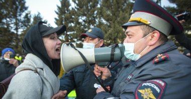 A woman argues with a police officer during a protest in support of jailed opposition leader Alexei Navalny in Ulan-Ude, the regional capital of Buryatia, a region near the Russia-Mongolia border, Russia, April 21, 2021. (AP Photo)