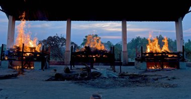 Burning pyres of victims who lost their lives due to COVID-19 are seen at an open crematorium in Bangalore, India, April 26, 2021. (AFP Photo)
