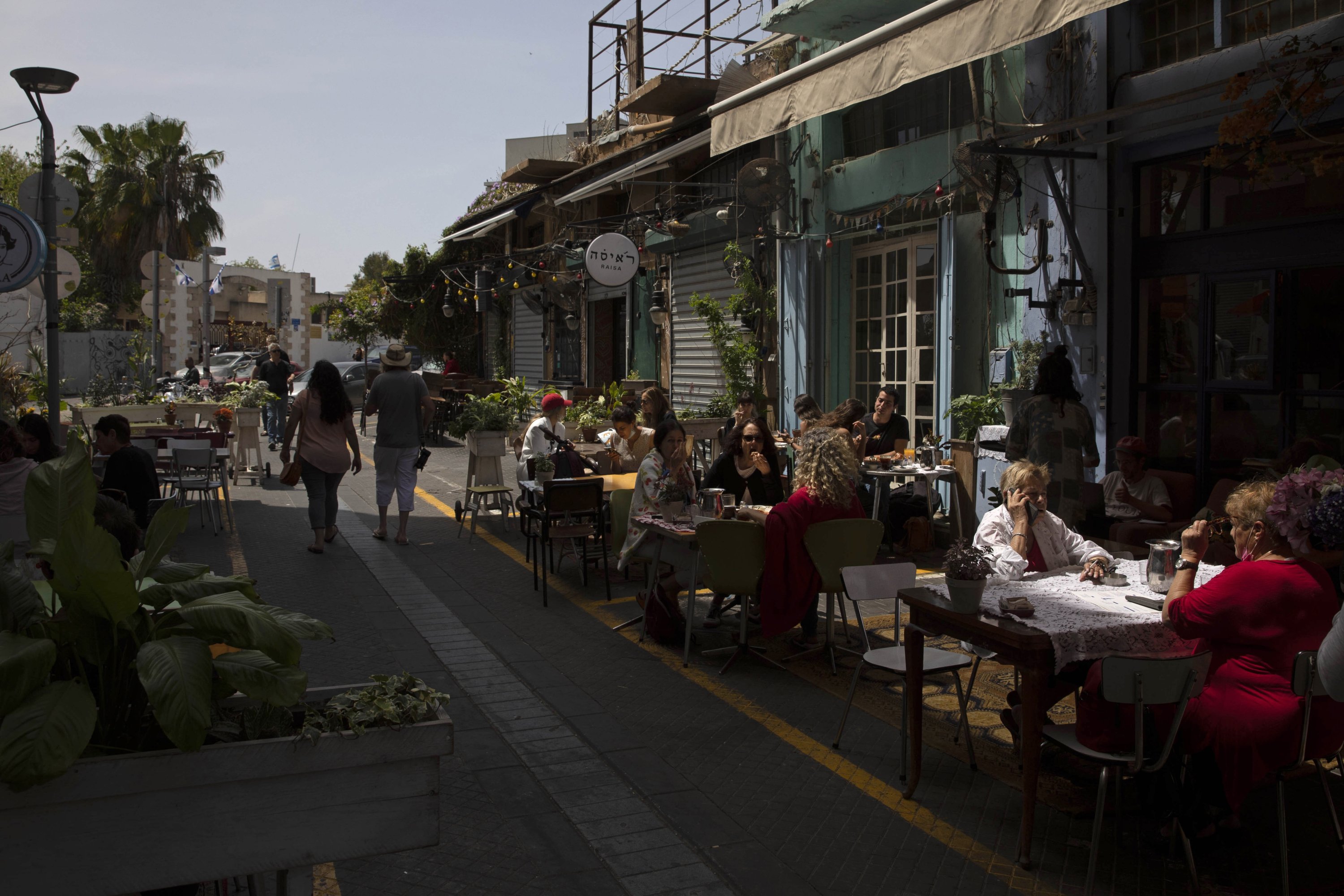 People sit in a restaurant in the Jaffa neighborhood of Tel Aviv, Israel, April 21, 2021. (Sebastian Scheiner via AP)