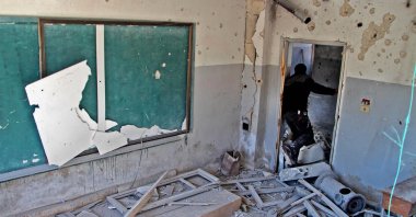 A displaced Syrian man checks a school that was reportedly targeted by Bashar Assad regime's airstrike near the town of Adwan, Idlib province, northwestern Syria, March 3, 2020. (AFP Photo)