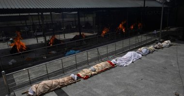 Bodies of COVID-19 victims are lined up before cremation at a cremation ground in New Delhi, India, April 28, 2021. (Money SHARMA via AFP)