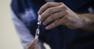 A health worker prepares a dose of the Oxford-AstraZeneca vaccine for COVID-19, as part of a priority vaccination program for people with disabilities at a vaccination center in Rio de Janeiro, Brazil, April 25, 2021. (AP Photo)