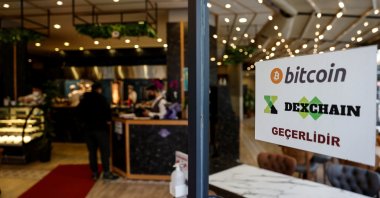 A sign at the entrance door of a kebab restaurant reads "We accept Bitcoin, Dexchain" in Istanbul, Turkey, April 27, 2021. (Reuters Photo)