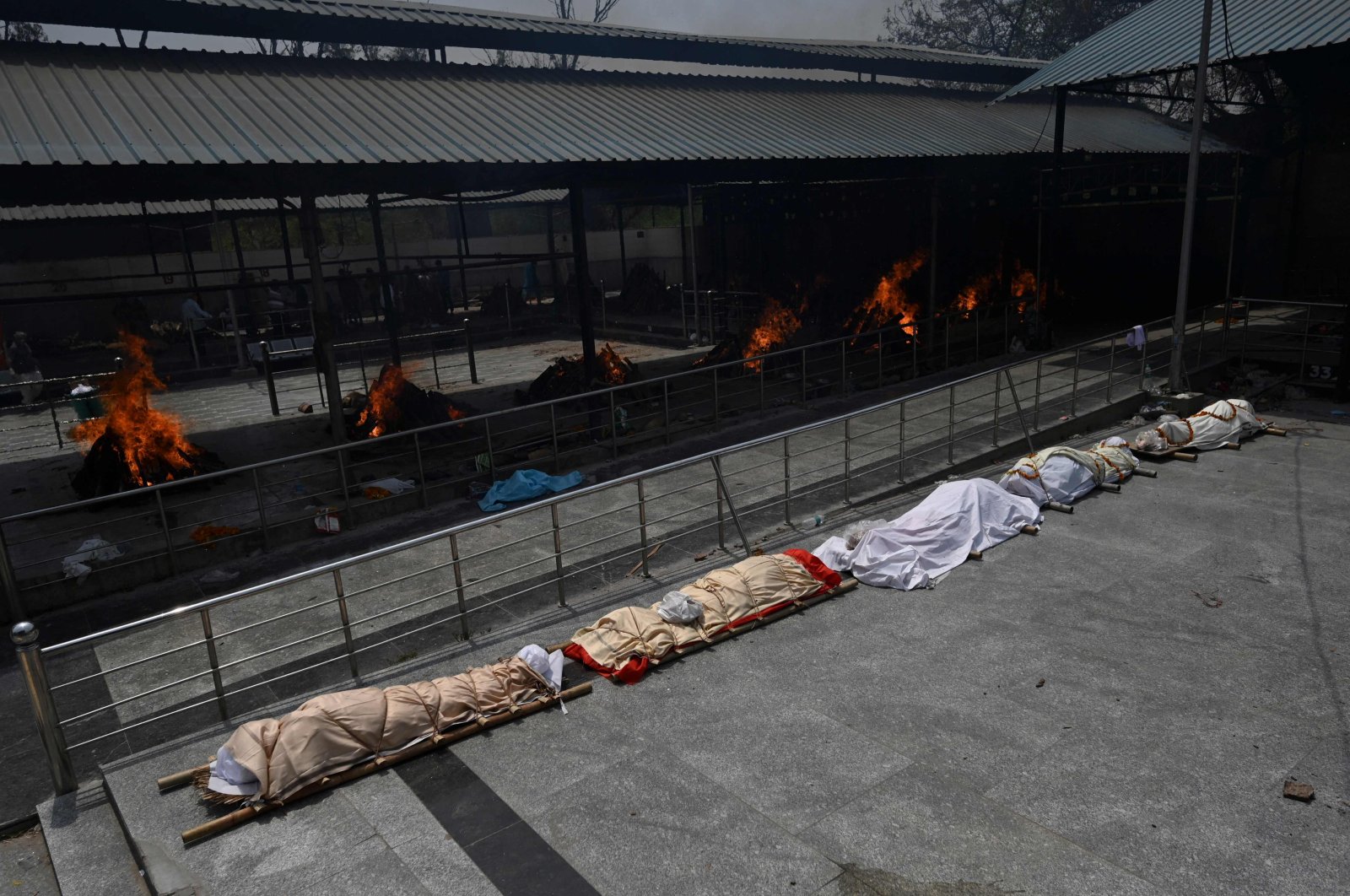 Bodies of COVID-19 victims are lined up before cremation at a cremation ground in New Delhi, India, April 28, 2021. (Money SHARMA via AFP)