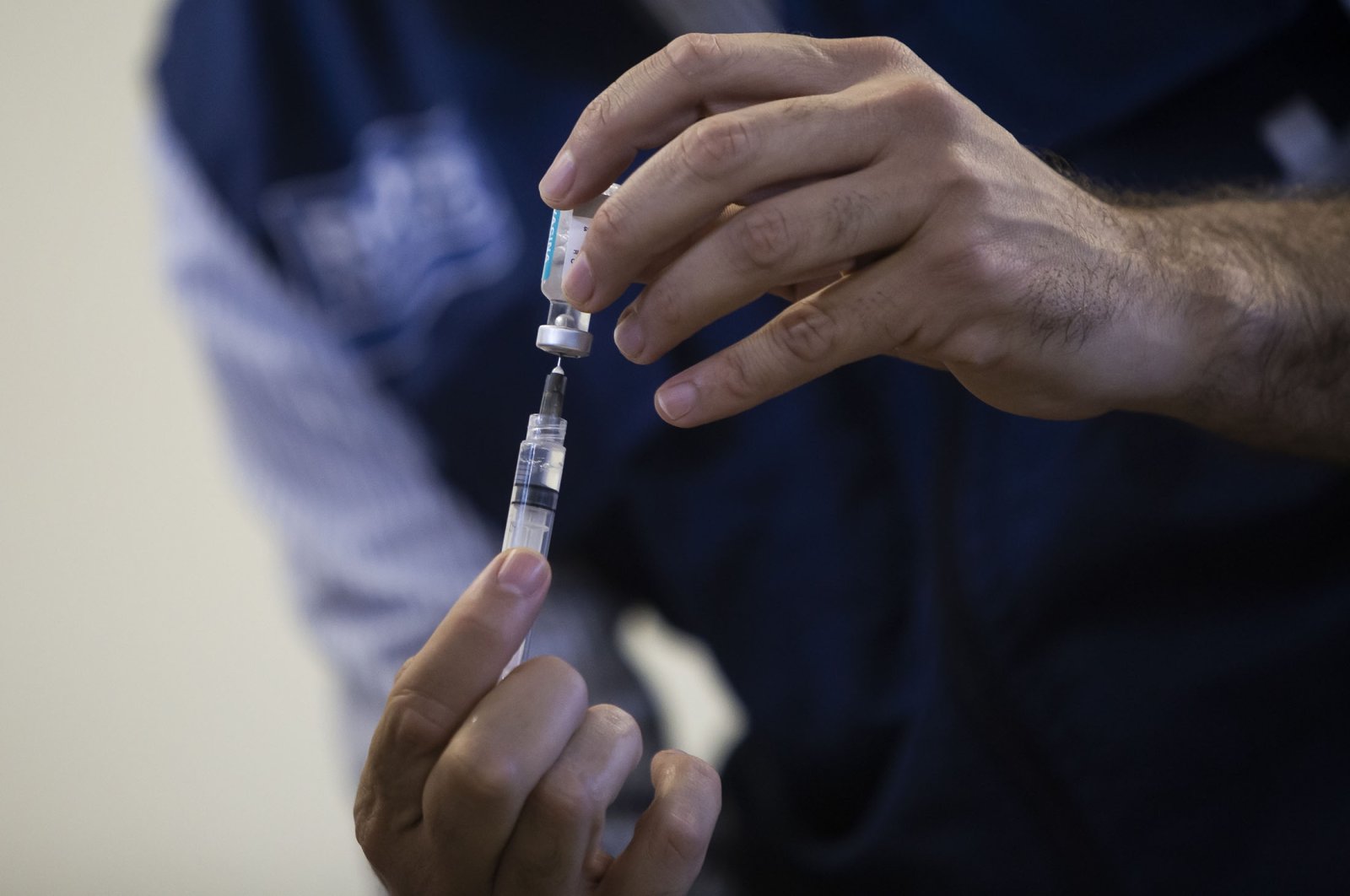 A health worker prepares a dose of the Oxford-AstraZeneca vaccine for COVID-19, as part of a priority vaccination program for people with disabilities at a vaccination center in Rio de Janeiro, Brazil, April 25, 2021. (AP Photo)