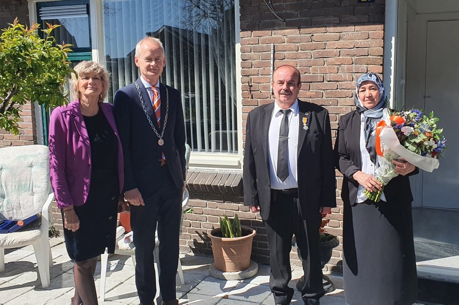 Selahattin Asal (2nd in right) and his wife receives royal medal from Dutch authorities, Huizen, Netherlands, April 27, 2021. (DHA)