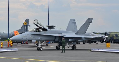 A technician stands in front of the Finnish Air Forces' McDonnell Douglas F/A-18C Hornet, HN-423, in Oulu, Northern Ostrobothnia, Finland, Aug. 9, 2014. (Shutterstock Photo)