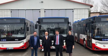 Turkey's Ambassador to Prague Egemen Bağış (2L) and officials from both countries pose in front of the BMC buses during the ceremony held in Prague, Czech Republic, April 29, 2021. (AA Photo)