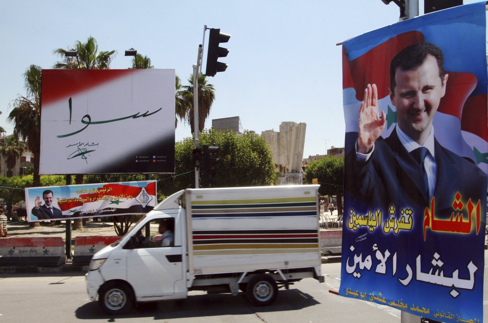 Campaign posters for the upcoming presidential election adorn a street in Damascus, Syria, May 12, 2014. (AP Photo)