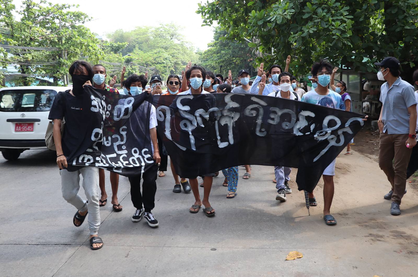 Protesters marching with banners as they take part in a demonstration against the military coup in Insein township, Yangon, Myanmar, April 29, 2021. (AFP Photo)