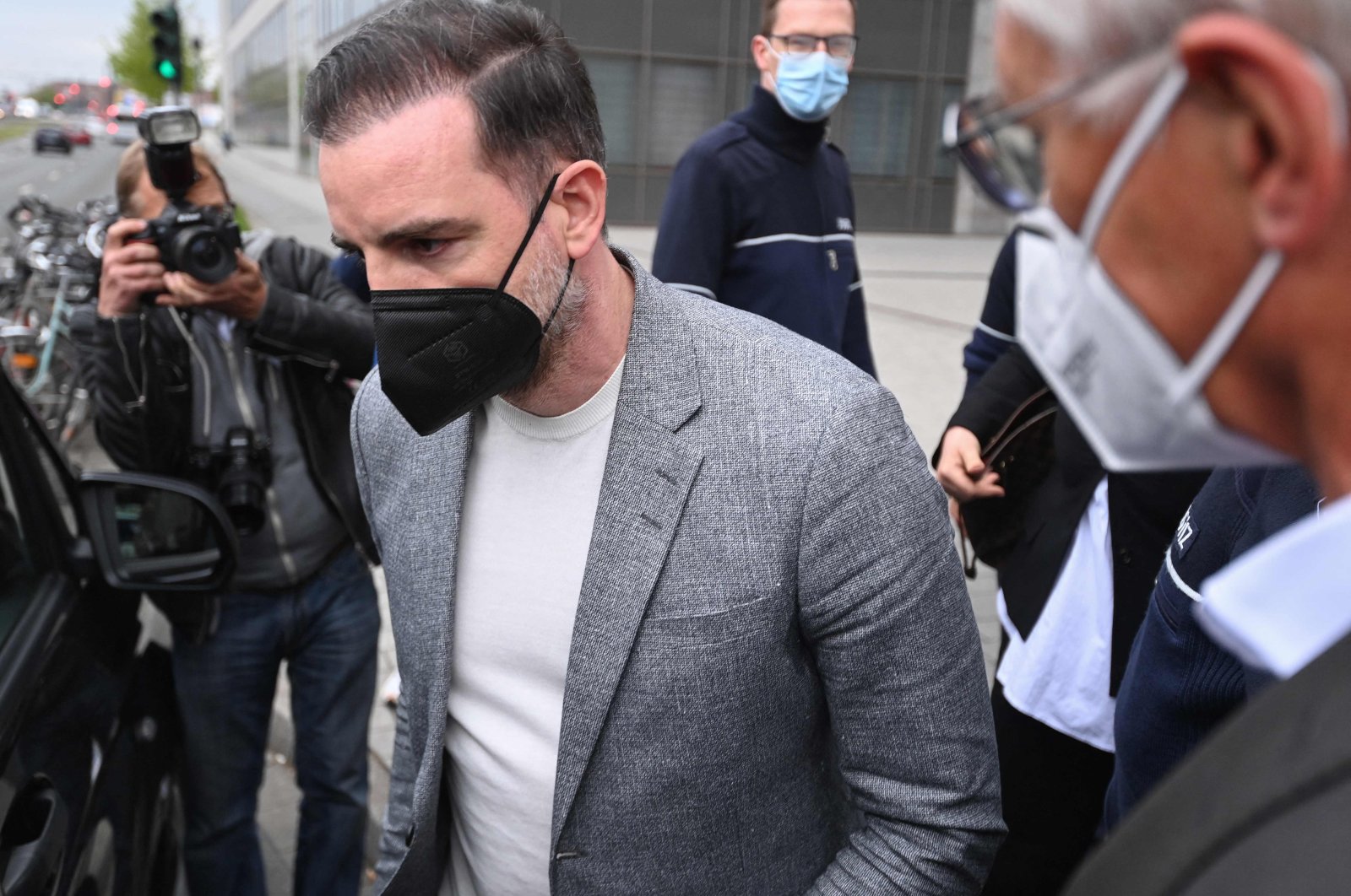 Former German footballer Christoph Metzelder (C) leaves the district court for the start of the trial against him on child pornography charges in Duesseldorf, western Germany, April 29, 2021. (AFP Photo)