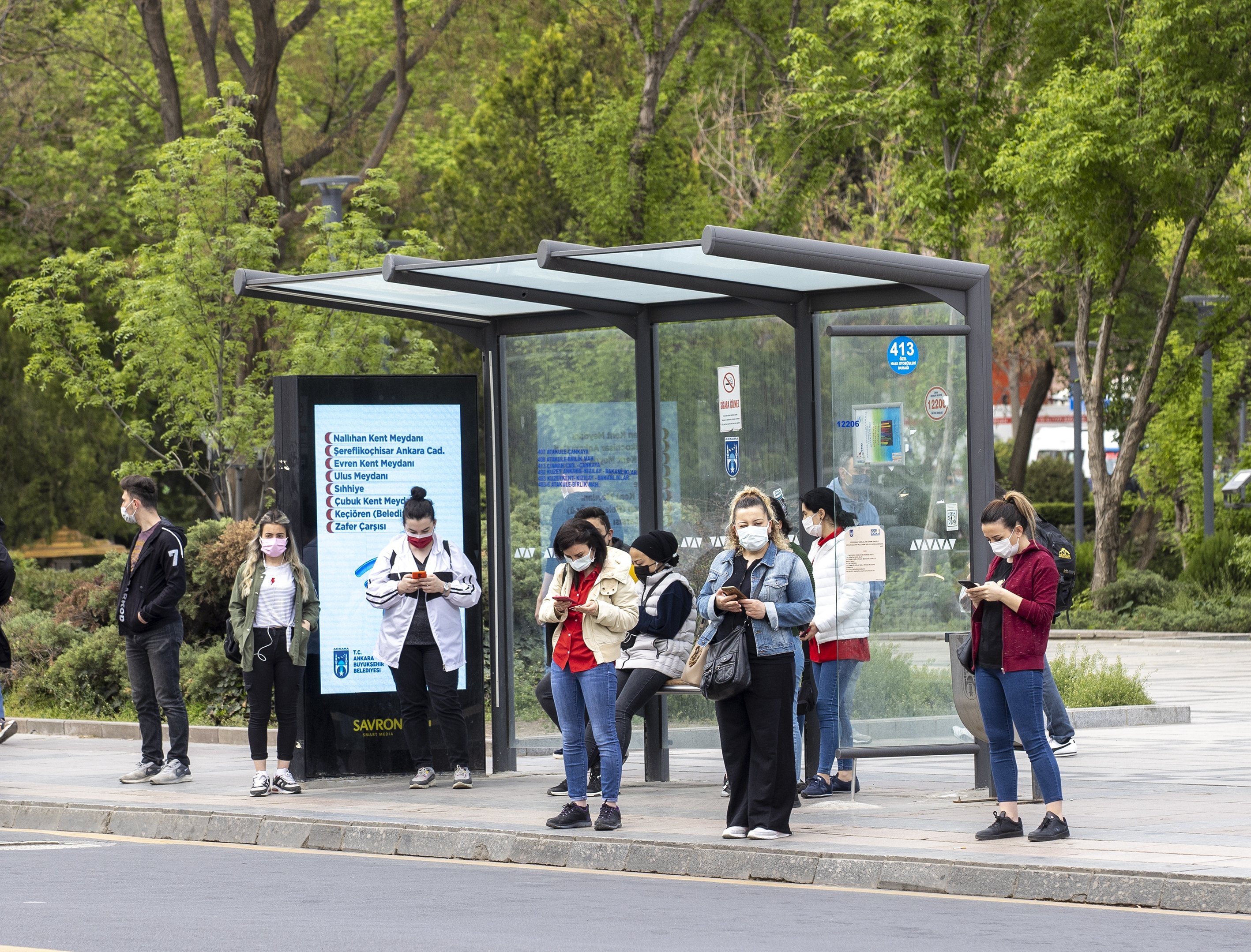 People wait at a bus stop on the first day of the three-week COVID-19 lockdown, Ankara, Turkey, April 30, 2021. (AA Photo)