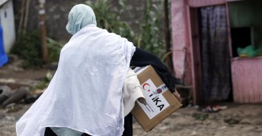 An Ethiopian woman carries an aid package delivered by TIKA in Addis Ababa, Ethiopia, April 29, 2021. (AA)