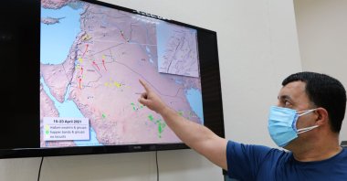 Zoology professor Ali Satar points out the route of desert locusts, in Diyarbakır, Turkey, April 30, 2021. (DHA Photo)