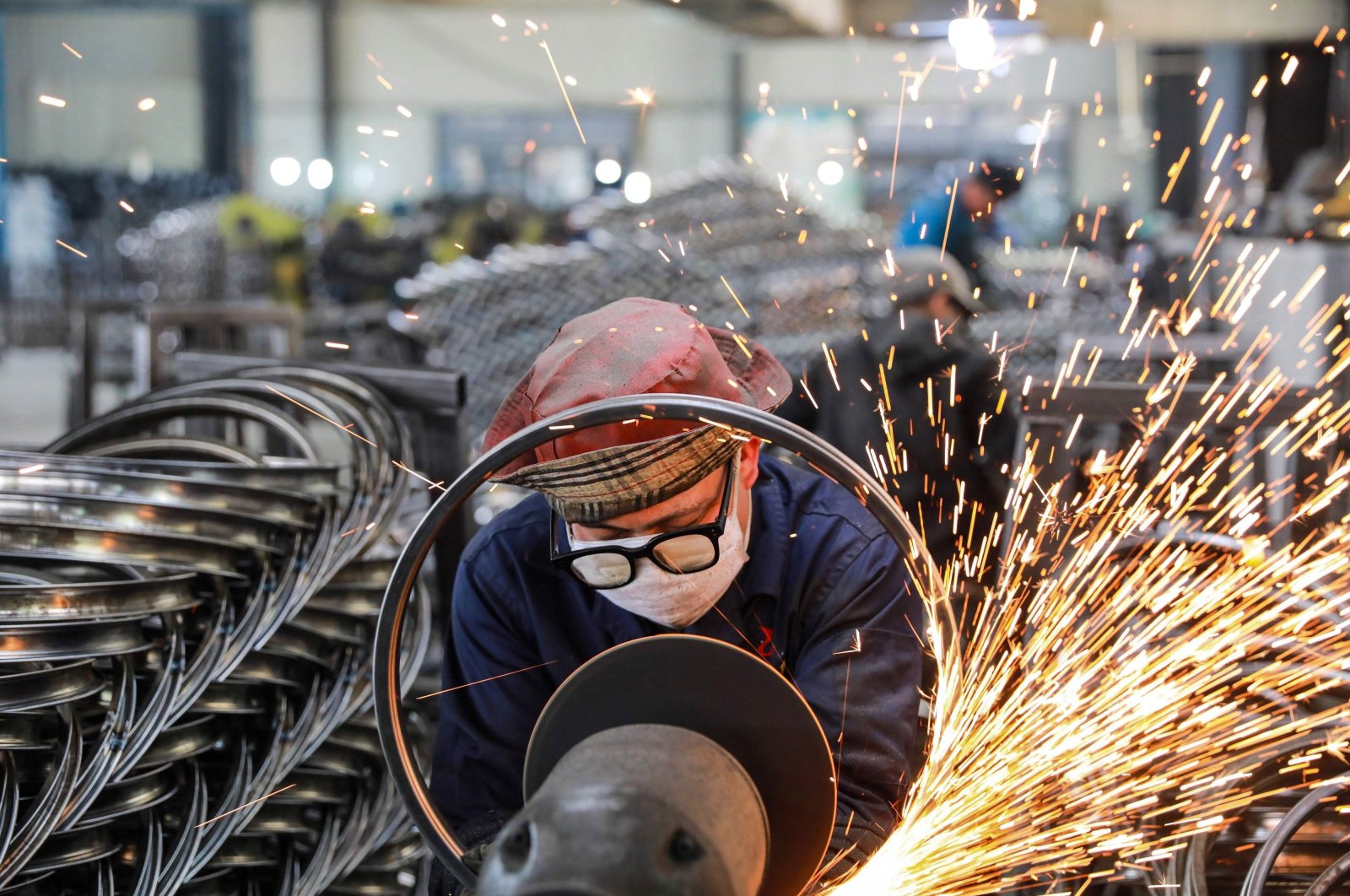 A worker welds wheels at a factory in Hangzhou, in eastern Zhejiang province, China, April 16, 2021. (AFP Photo)