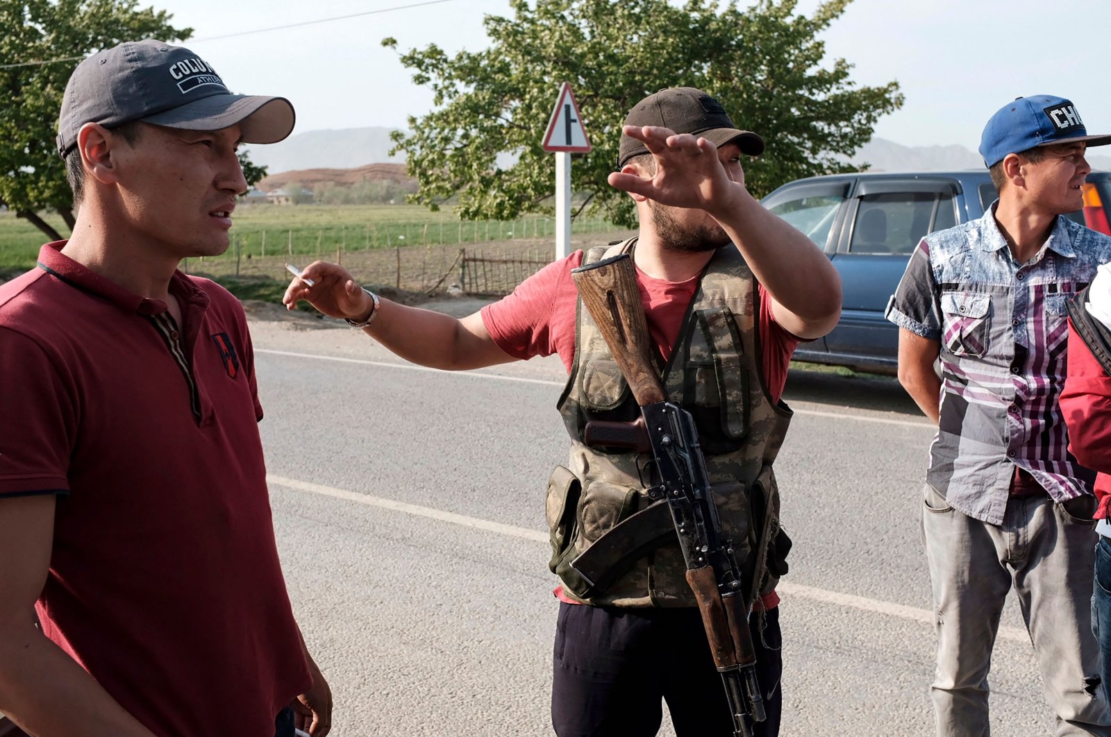 Men from the village of Kyzyl-Bel keep watch on a road during fighting along the Kyrgyz-Tajik disputed border region near Tajikistan, in Batken, southwest Kyrgyzstan, April 30, 2021. (AFP Photo)