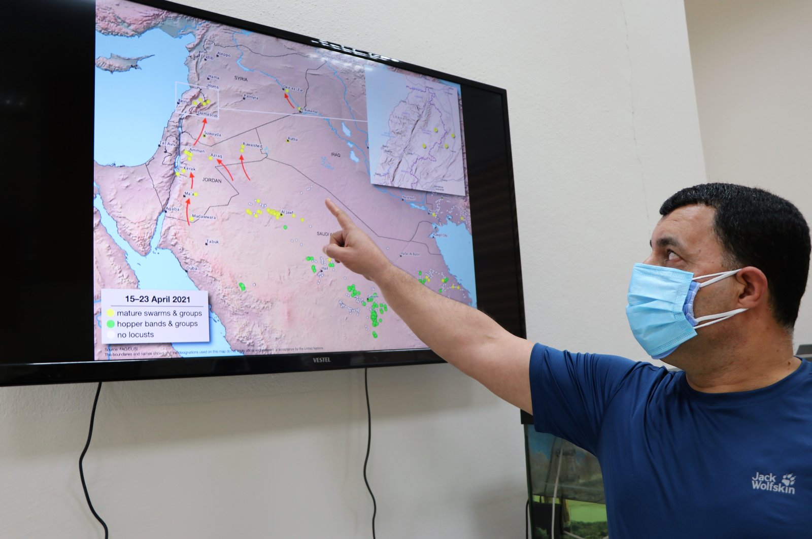 Zoology professor Ali Satar points out the route of desert locusts, in Diyarbakır, Turkey, April 30, 2021. (DHA Photo)