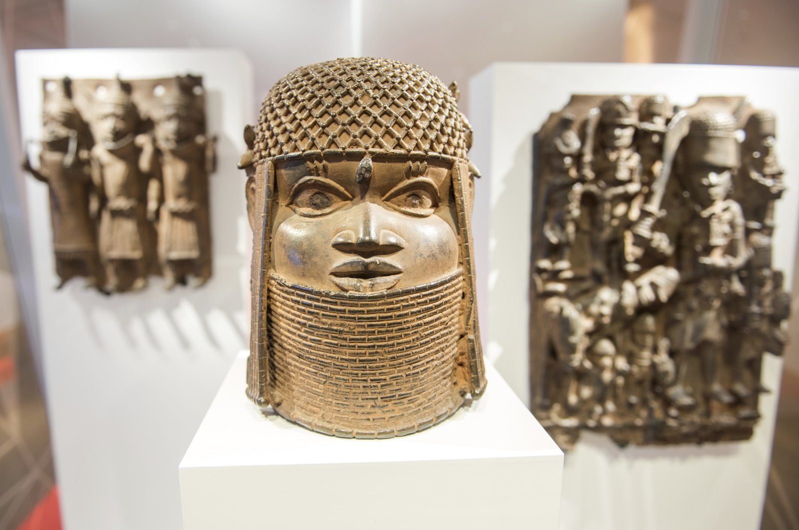 Three pieces of the famed Benin Bronzes are displayed at the Museum for Art and Crafts in Hamburg, Germany, Feb. 14, 2018. (dpa via AP)