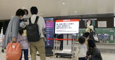 People gather around a ticket gate as train services are suspended following an earthquake in Sendai, Miyagi prefecture, Japan, May 1, 2021. (Kyodo via Reuters)