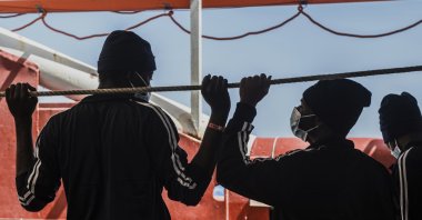 Migrants look at the sea from aboard the Ocean Viking during its navigation in the Mediterranean Sea, April 29, 2021. (SOS Mediterranee via AP)