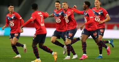 Lille's Burak Yılmaz (C) celebrates scoring his team's first goal with teammates against Nice at Stade Pierre-Mauroy, Lille, France, May 1, 2021.