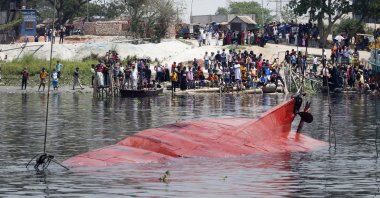 Locals gather to watch the aftermath of a boat capsizing in the Shitalakkhya river in Narayanganj, Dhaka, Bangladesh, April 5, 2021. (EPA Photo)