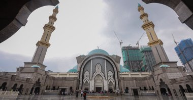 Worshippers leave Wilayah Mosque after their prayers on the first Friday of the holy month of Ramadan, Kuala Lumpur, Malaysia, April 16, 2021. (Photo by Getty Images)
