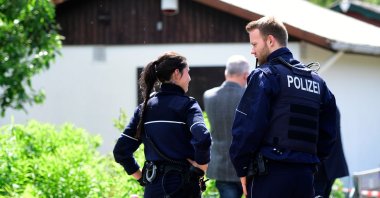 Police officers stand in front of a summer house where the sexual abuse of children is suspected to have taken place in Muenster, western Germany on June 6, 2020. (AFP Photo)