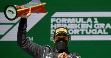 Mercedes' British driver Lewis Hamilton celebrates on the podium after winning the Portuguese Formula One Grand Prix race at the Algarve International Circuit in Portimao, Portugal, May 2, 2021. (AFP Photo)