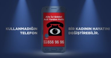 A poster prepared for the "A phone can save a woman's life" project, in Istanbul, Turkey. (DHA Photo)