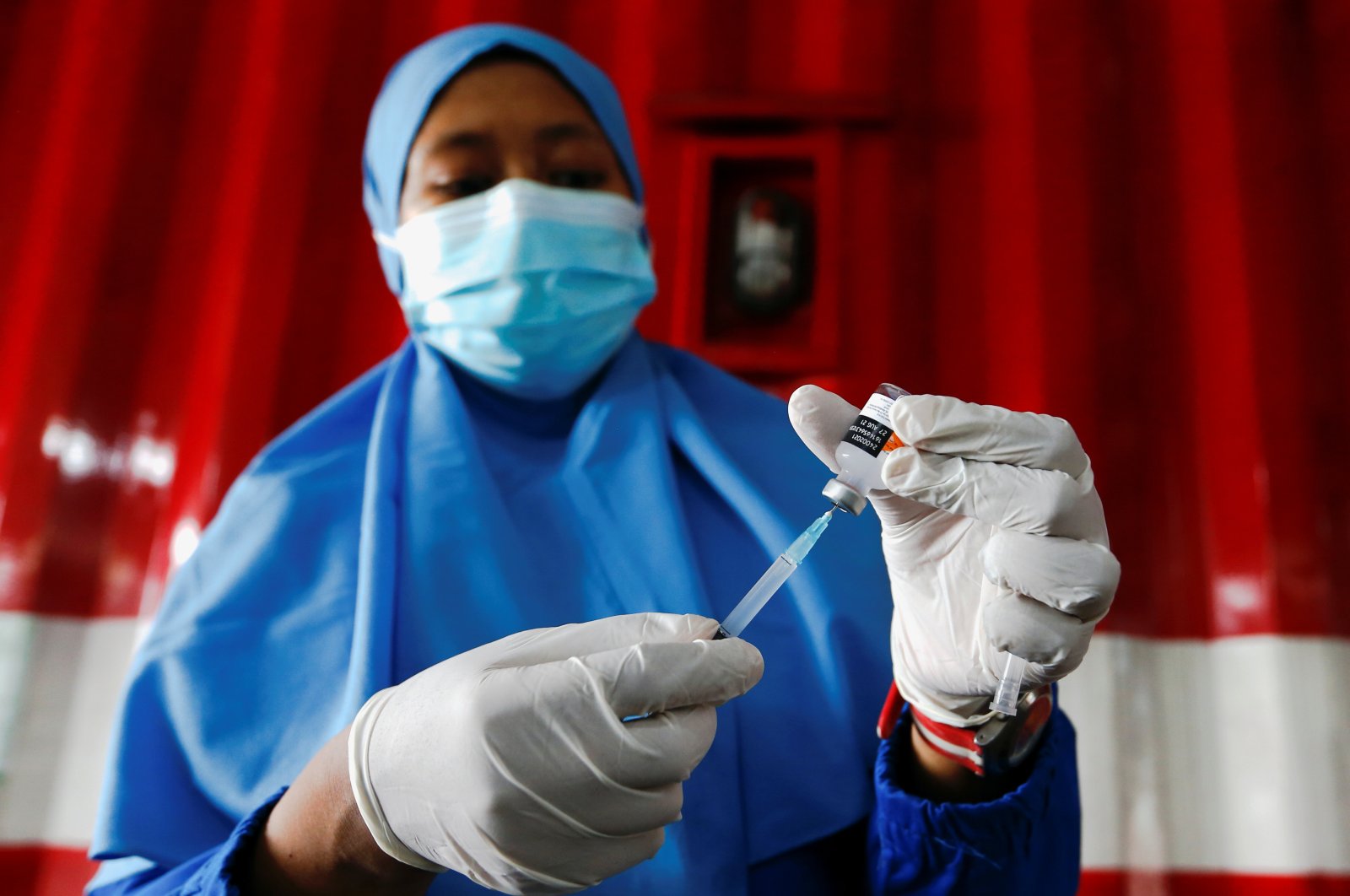A health care worker prepares a dose of China's Sinovac Biotech vaccine for the coronavirus disease (COVID-19) at a drive-thru vaccination station, as a mass vaccination program continues in Jakarta, Indonesia, April 30, 2021. (Reuters Photo)