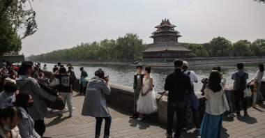 A couple pose for their pre-wedding photos near the Forbidden City in Beijing, China, May 3, 2021. (EPA Photo)