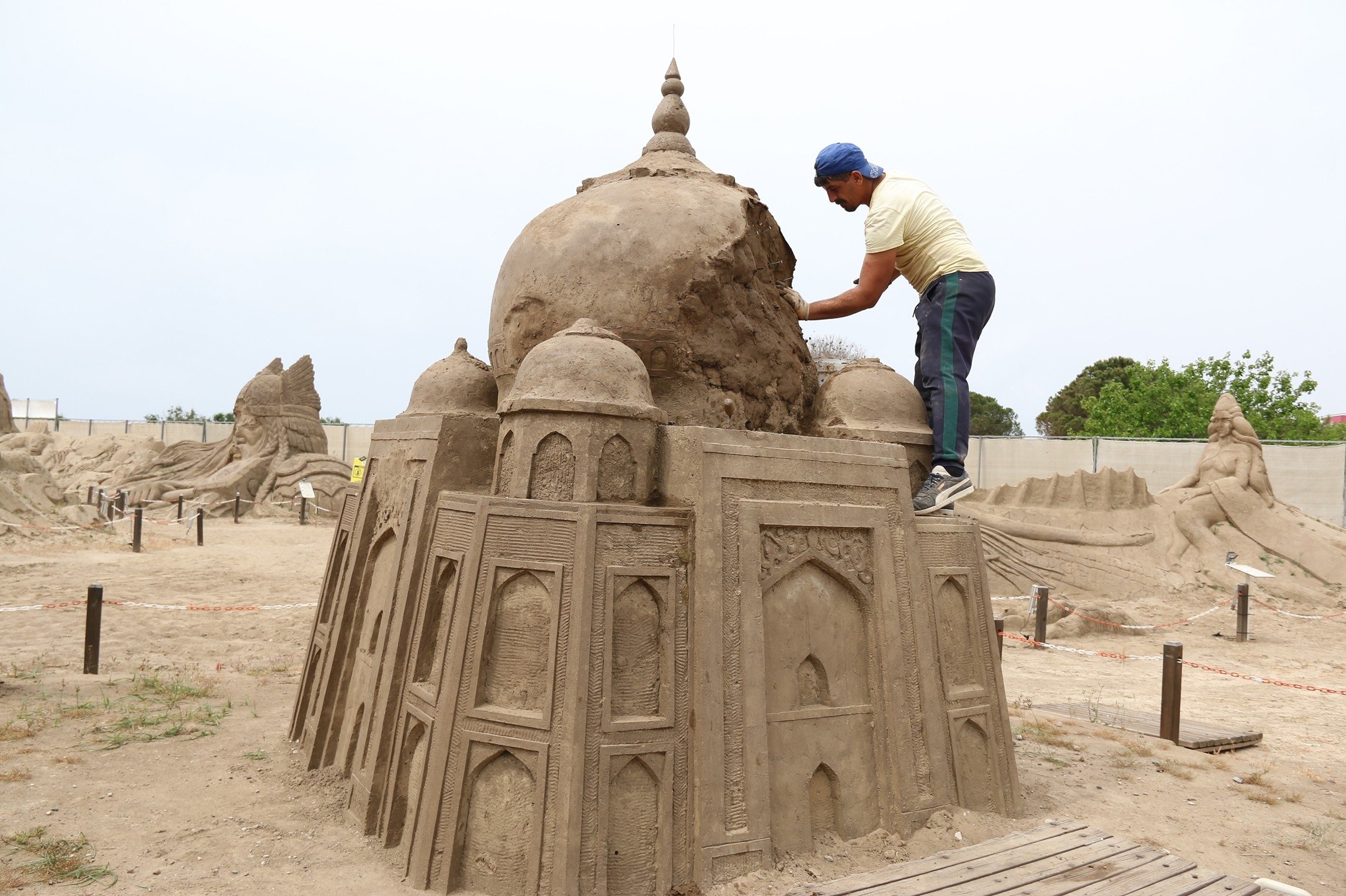 A sculptor works on his sand sculpture for the International Sand Sculpture Festival, Antalya, southern Turkey, May 4, 2021. (IHA Photo)