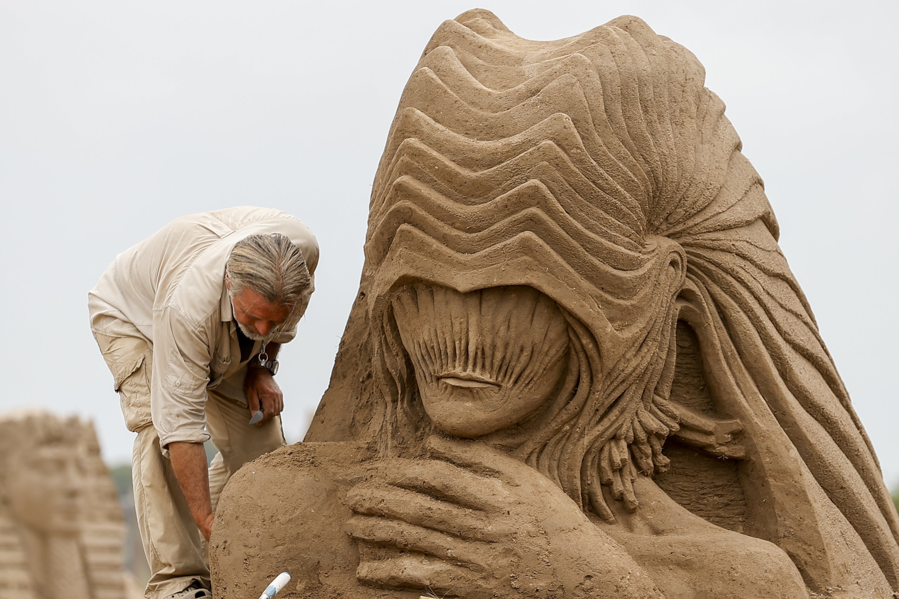 A sculptor works on his sand sculpture for the International Sand Sculpture Festival, Antalya, southern Turkey, May 4, 2021. (AA Photo) 