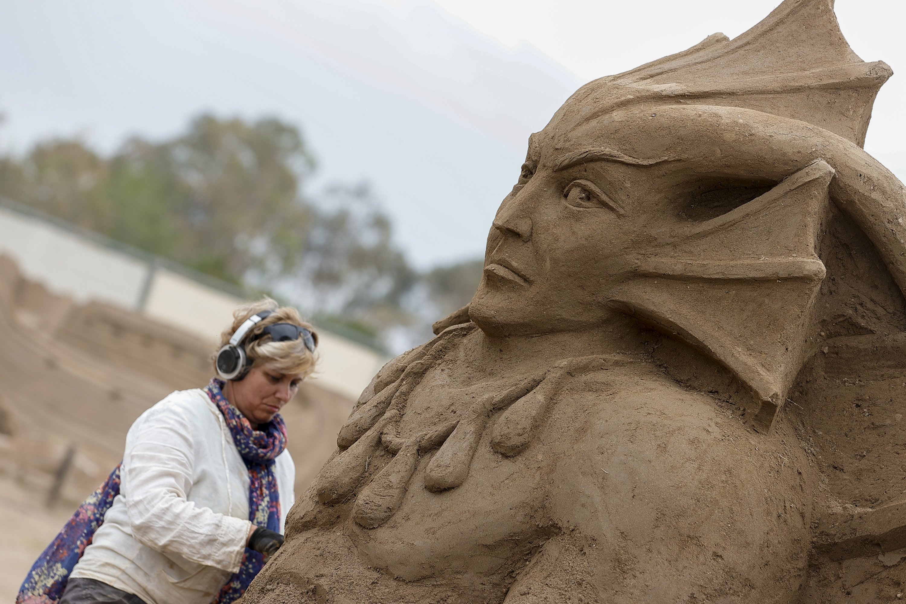 A sculptor works on her sand sculpture for the International Sand Sculpture Festival, Antalya, southern Turkey, May 4, 2021. (AA Photo) 