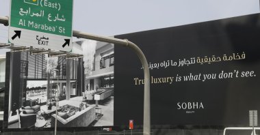 A billboard advertises a luxury residential project along a highway in Dubai, United Arab Emirates, May 5, 2021. (AP Photo)