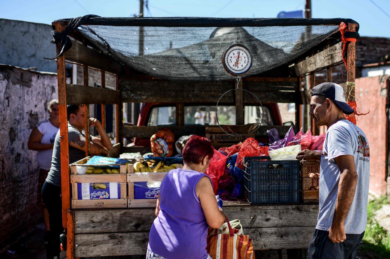 A man sells fruit and vegetables from a truck in the San Petersburgo neighborhood of La Matanza municipality, Buenos Aires, Argentina, April 12, 2021. (AFP Photo)