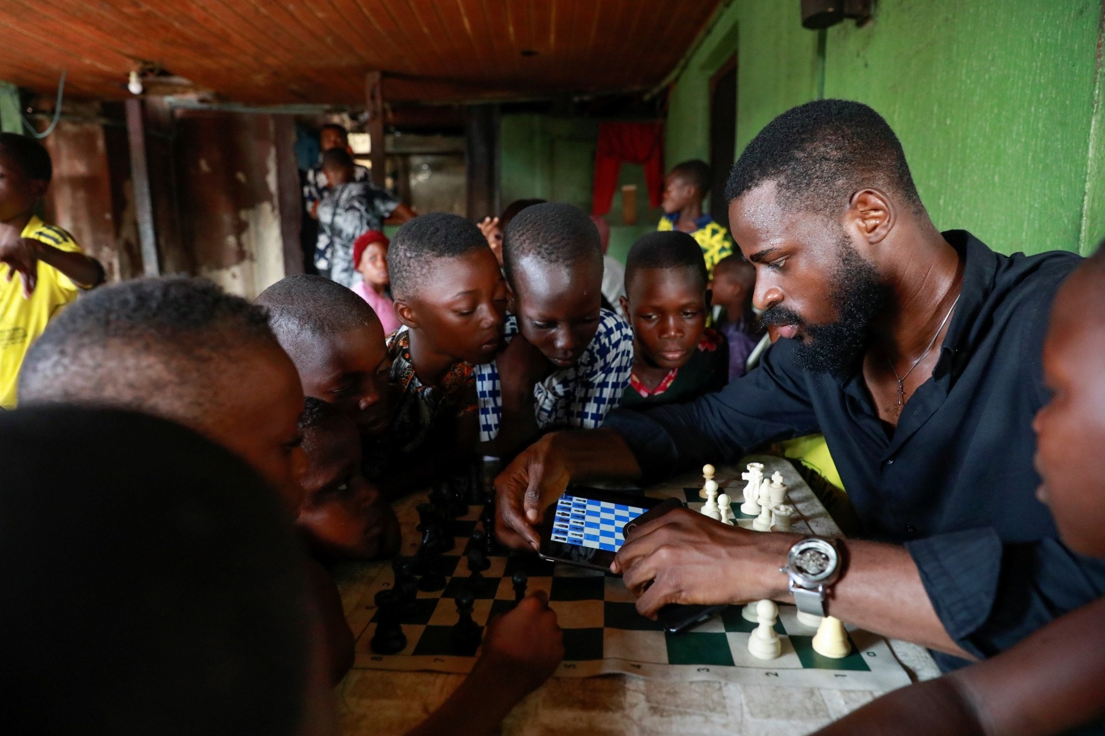 Babatunde Onakoya, 26, teaches children to play chess at a community palace in Makoko, Lagos, Nigeria, May 5, 2021. (Reuters Photo)