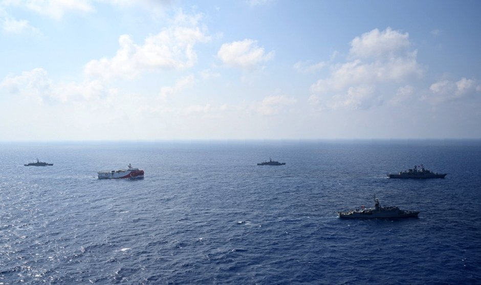 Turkey's research vessel Oruç Reis, in red and white, is surrounded by Turkish navy vessels as it was heading in the west of Antalya on the Mediterranean, Turkey, Aug 10, 2020. (AP Photo)