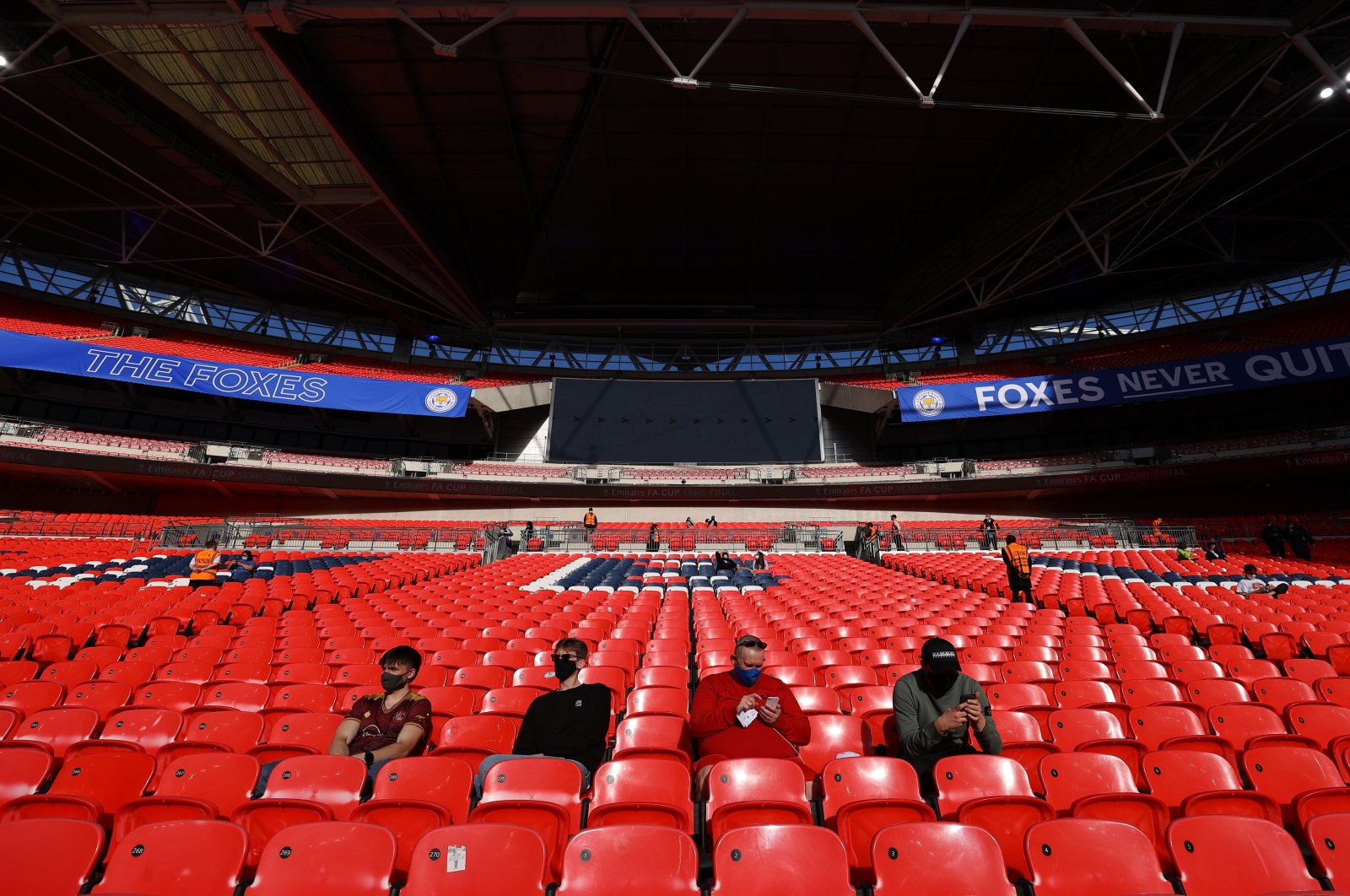 Supporters sit in the stands of the Wembley Stadium before the start of the FA Cup semifinal match between Leicester City and Southampton as thousands of fans returned to the stands as part of the COVID-19 events trial, U.K., April 18, 2021. (Reuters Photo)