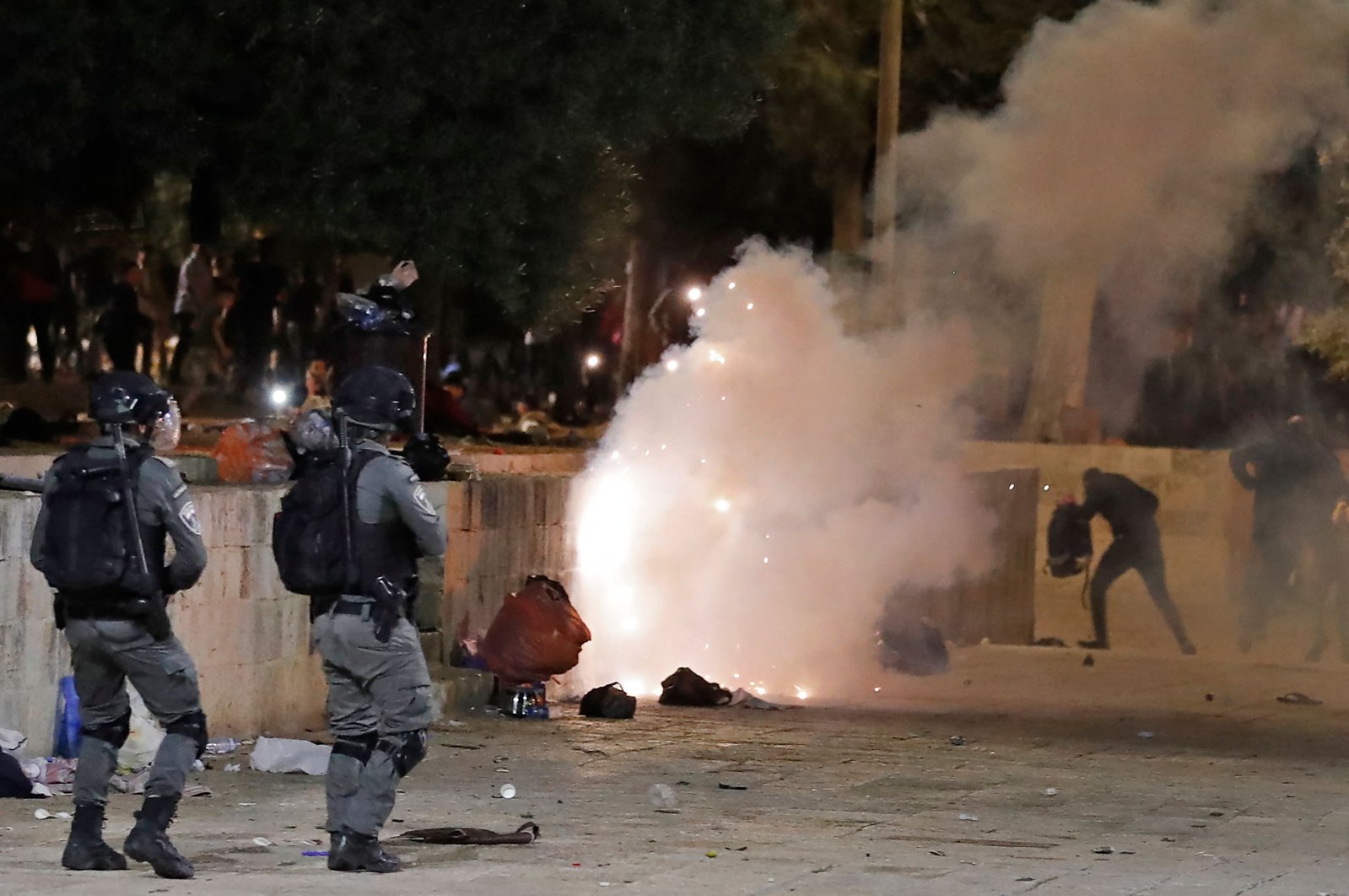 Tear gas billows as Israeli police officers raid the Al-Aqsa Mosque and attack Palestinian worshippers in East Jerusalem, May 7, 2021. (AFP Photo)