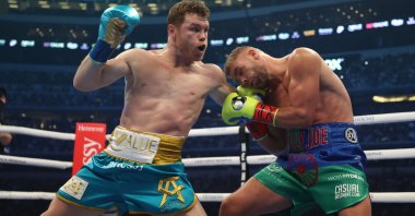 Canelo Alvarez punches Billy Joe Saunders during their fight for Alvarez's WBC and WBA super middleweight titles and Saunders' WBO super middleweight title at the AT&T Stadium, Arlington, Texas, May 08, 2021.