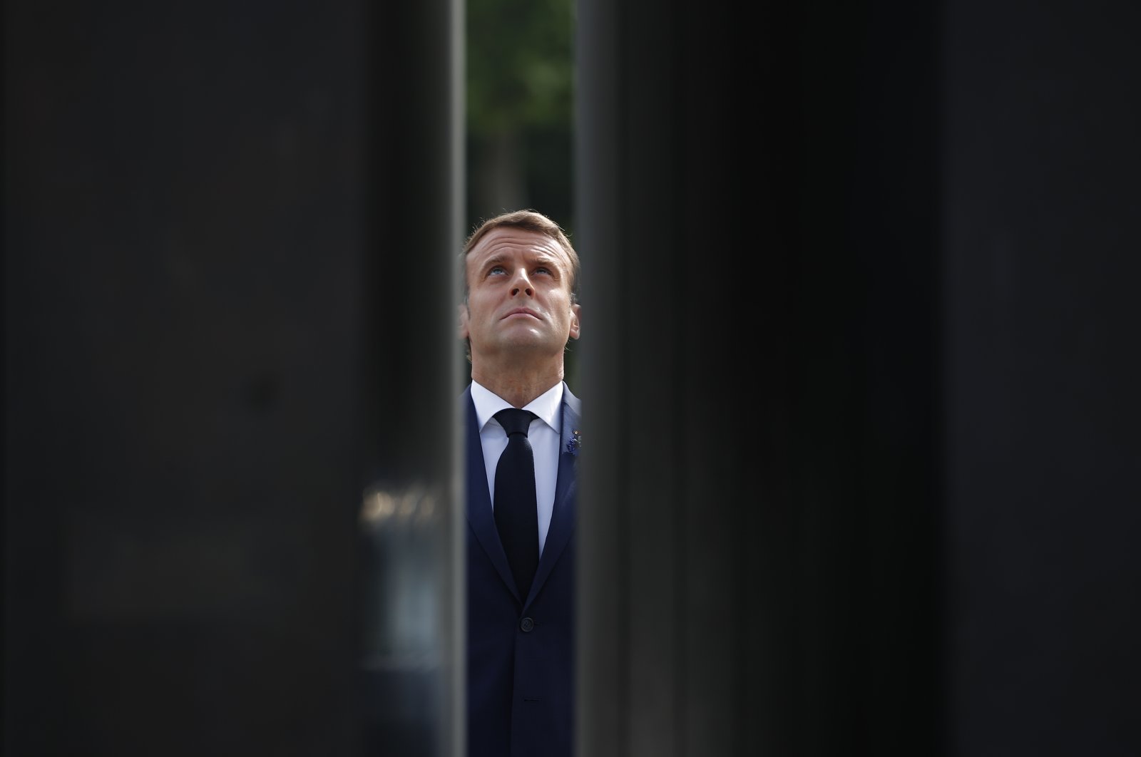 French President Emmanuel Macron looks up at the statue of General Charles de Gaulle during Victory in Europe Day ceremonies, May 8, 2020. (AP Photo)