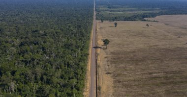 Highway BR-163 stretches between the Tapajos National Forest (L) and a soy field in Belterra, Para state, Brazil, Nov. 25, 2019. (AP File Photo)