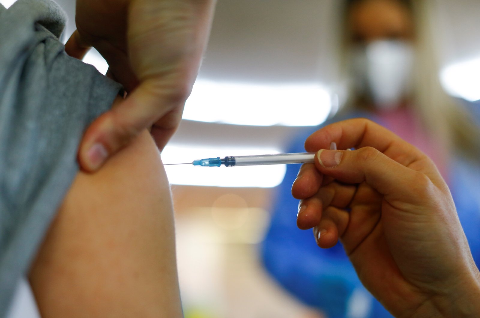 A person receives a dose of the Pfizer-BioNTech COVID-19 vaccine in the Central Mosque in the suburb of Ehrenfeld in Cologne, Germany, May 8, 2021. (Reuters Photo)