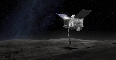 This artist's rendering shows the Origins Spectral Interpretation Resource Identification Security - Regolith Explorer (OSIRIS-REx) spacecraft contacting the asteroid Bennu with the Touch-And-Go Sample Arm Mechanism, made available by NASA on Sept. 6, 2016. (NASA via AP)